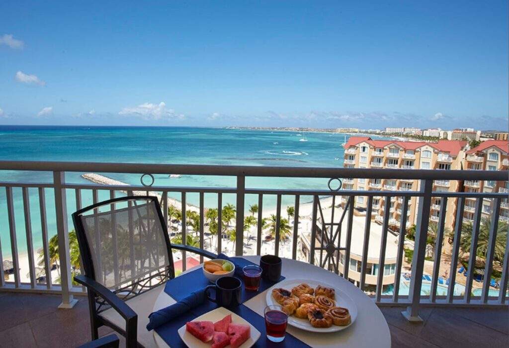 balcony with table and breakfast overlooking ocean