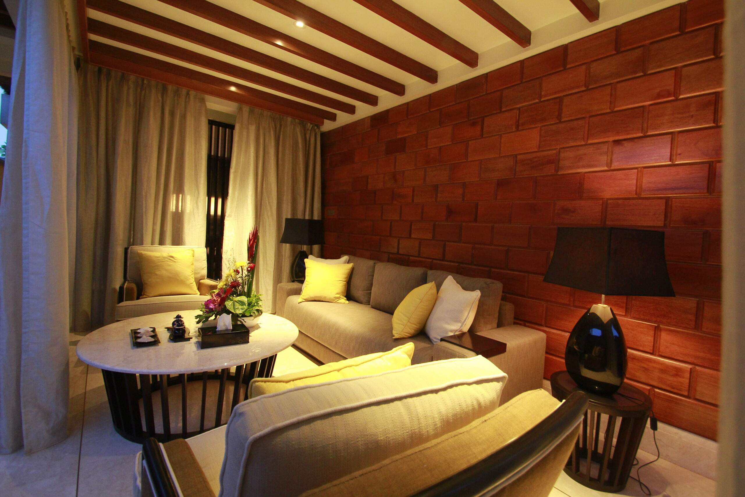 red brick wall with tan couches