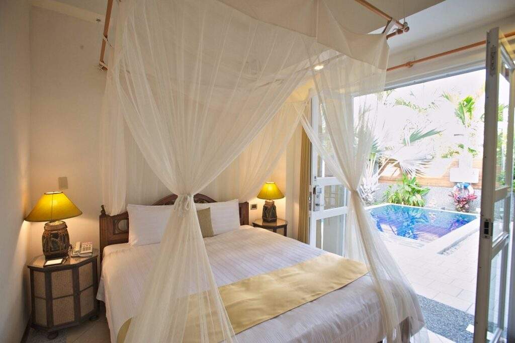 white resort room with large window open to outside