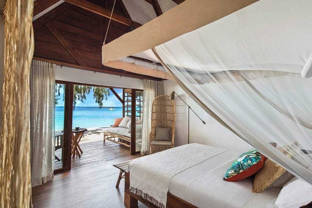tropical open air bedroom looking out onto ocean