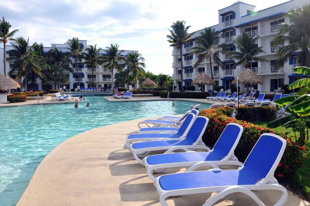 blue lounge chairs along resort pool