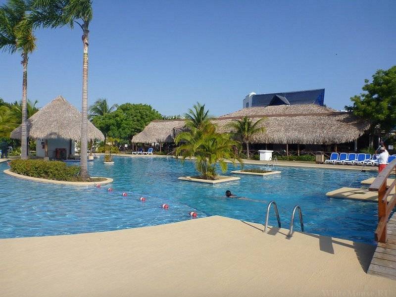 resort pool surrounded by huts