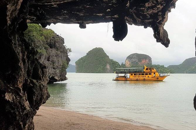 yellow boat at mouth of cave
