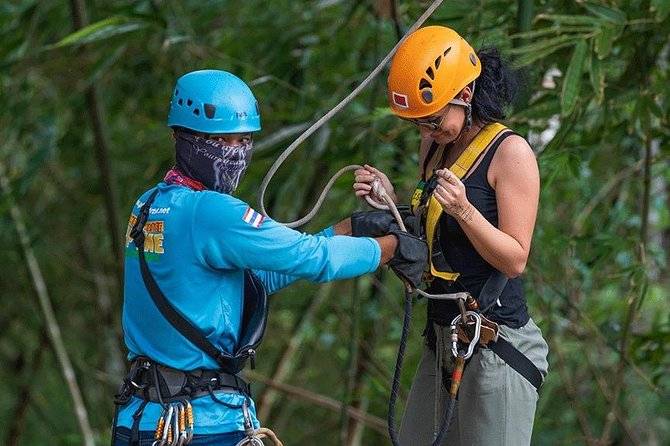 woman getting fitted for zipline