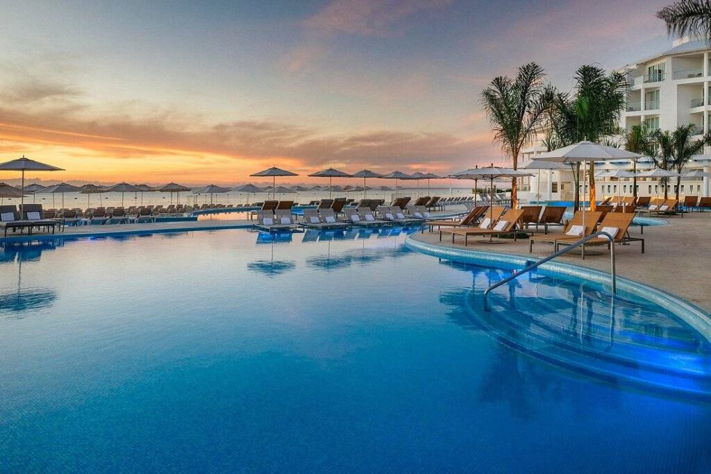 large beach resort pool at sunset