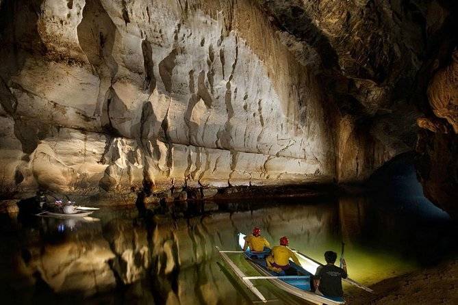 people in canoes in cave
