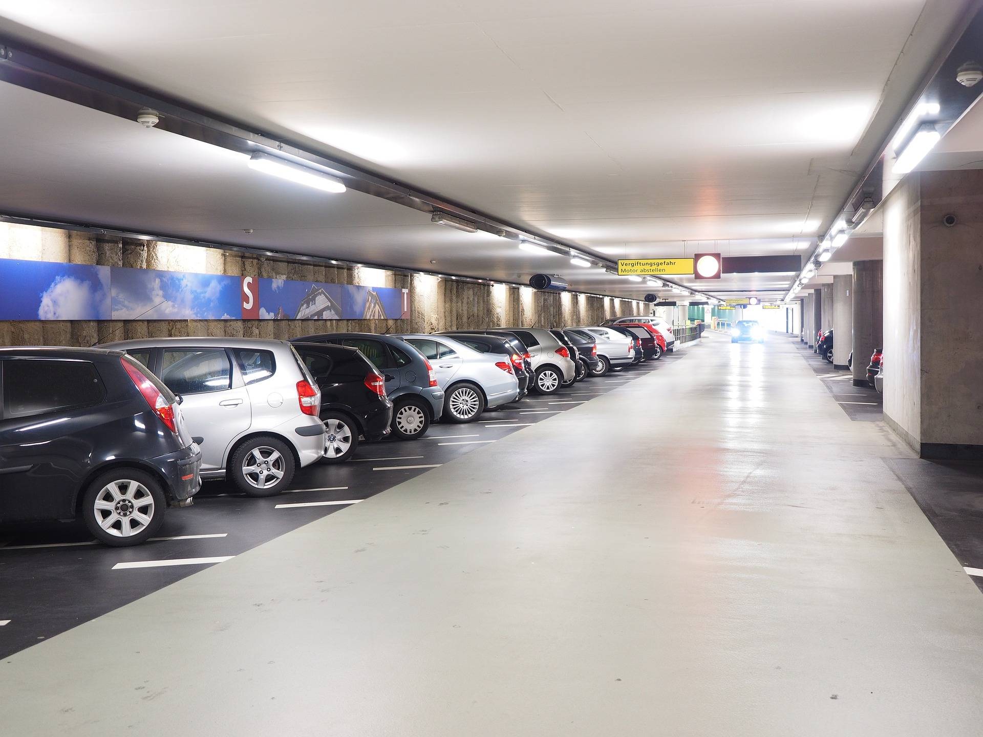 row of cars in parking garage