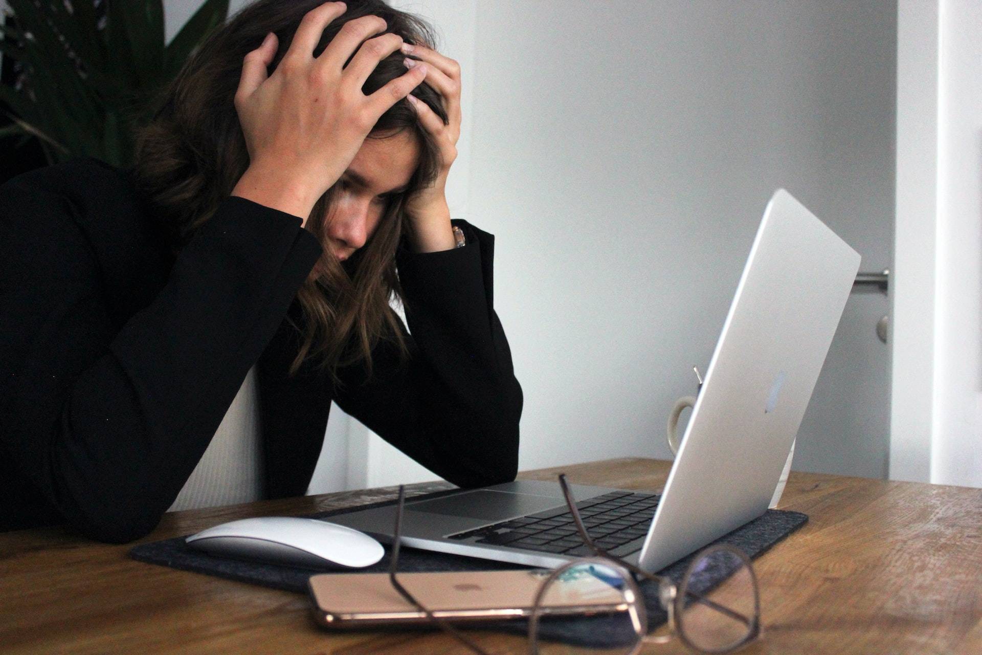 stressed woman in front of laptop