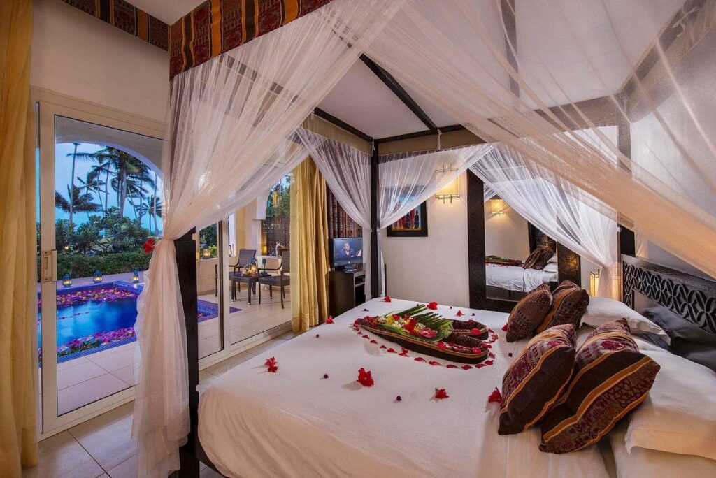 bed with canopy and rose petals on the bed